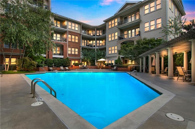 view of pool at dusk