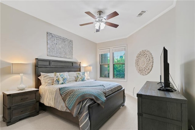 carpeted bedroom featuring ceiling fan and ornamental molding