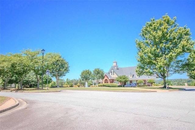 1420 Baygreen Rd, Suwanee, GA 30024 - view of asphalt street featuring curbs, street lights, and sidewalks