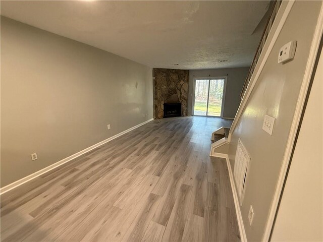 6745 Trafalger Sq, Norcross, GA 30093 - living room with a textured ceiling, a fireplace, and hardwood / wood-style flooring