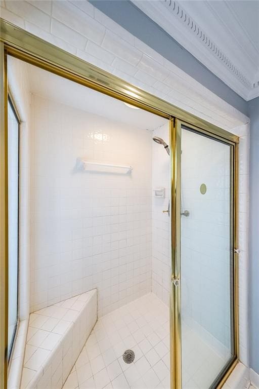 bathroom featuring a shower with door and crown molding