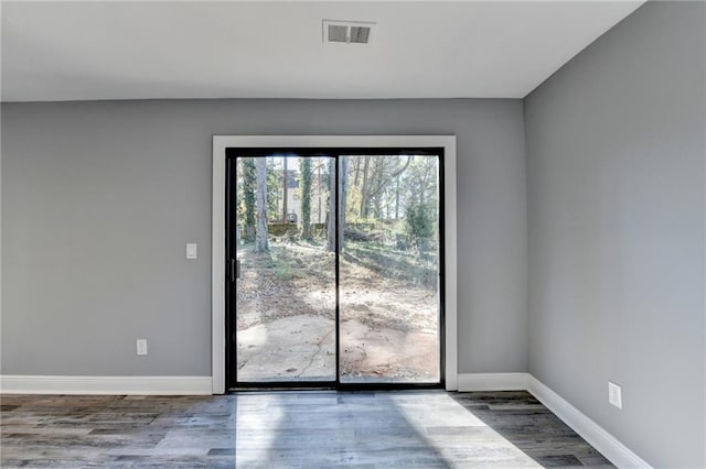 spare room with wood-type flooring