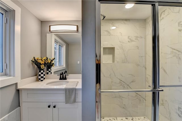 bathroom with vanity and a shower with door