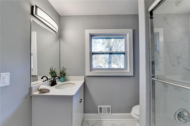 bathroom with vanity, an enclosed shower, and toilet