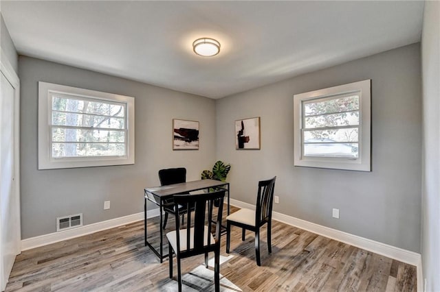 dining area with light wood-type flooring and a wealth of natural light