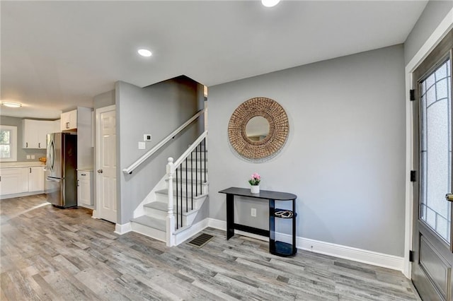 entryway with light hardwood / wood-style flooring