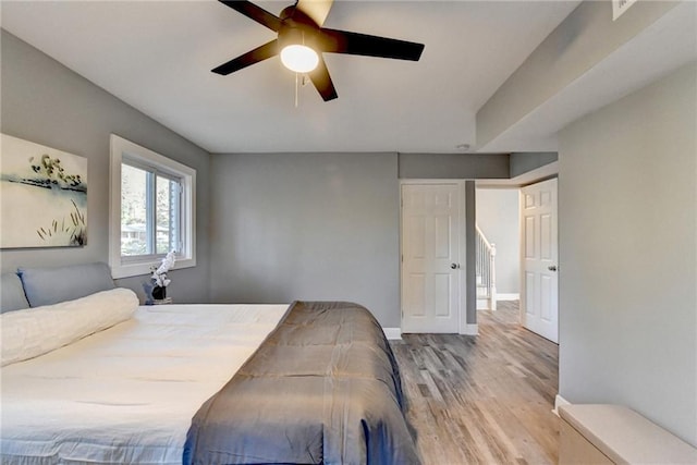 bedroom with light wood-type flooring and ceiling fan