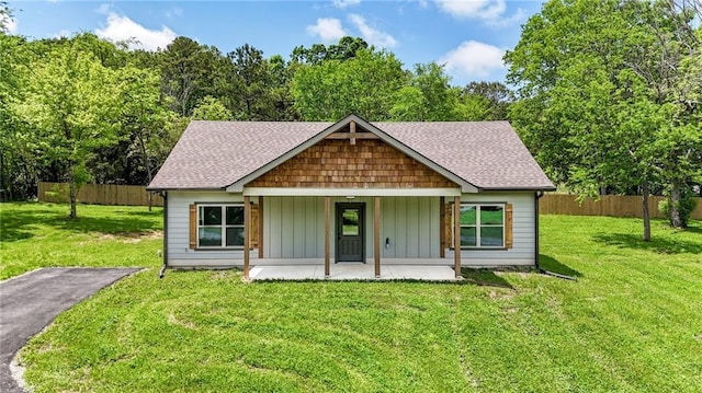 view of front of property featuring board and batten siding and roof with shingles