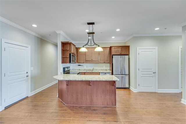 kitchen featuring pendant lighting, stainless steel appliances, light wood-type flooring, and crown molding