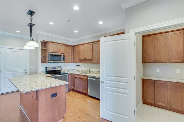 kitchen with appliances with stainless steel finishes, light hardwood / wood-style floors, kitchen peninsula, pendant lighting, and ornamental molding