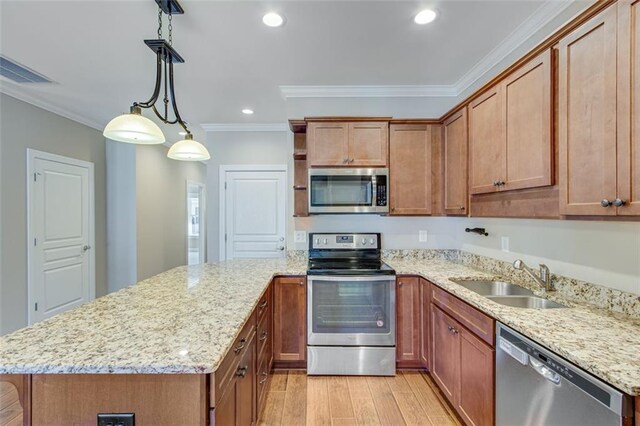 kitchen featuring appliances with stainless steel finishes, light stone counters, crown molding, light hardwood / wood-style flooring, and sink