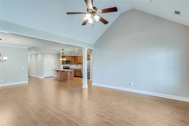 unfurnished living room featuring ceiling fan with notable chandelier, light wood-type flooring, and high vaulted ceiling