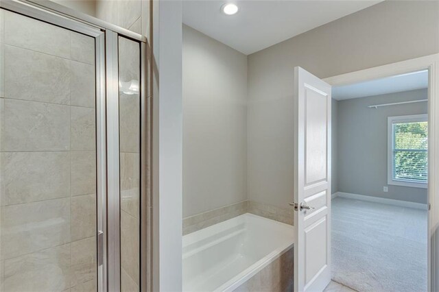 bathroom with separate shower and tub