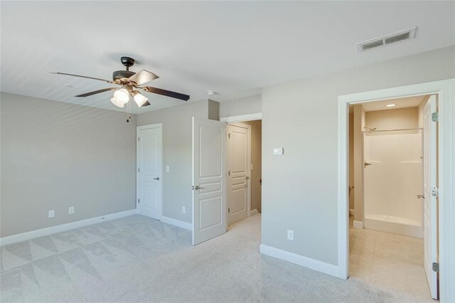 unfurnished bedroom with ceiling fan and light carpet