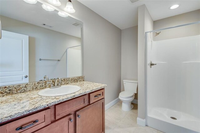 bathroom with a shower, vanity, and toilet