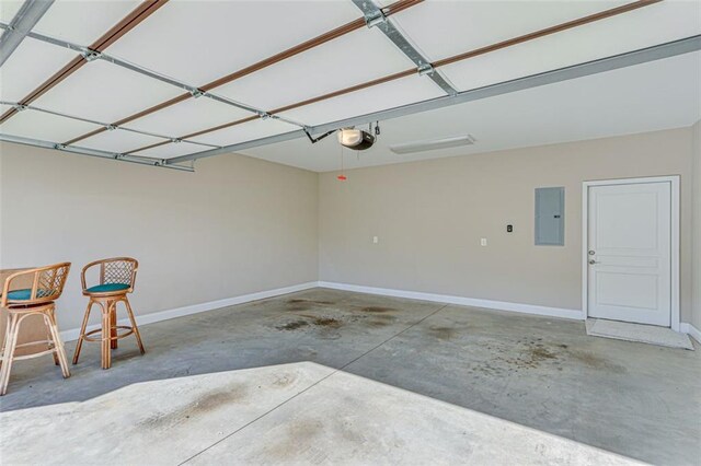 garage featuring a garage door opener and electric panel