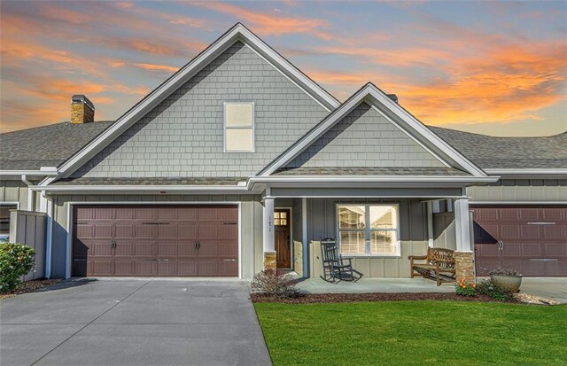 craftsman inspired home with covered porch and a yard