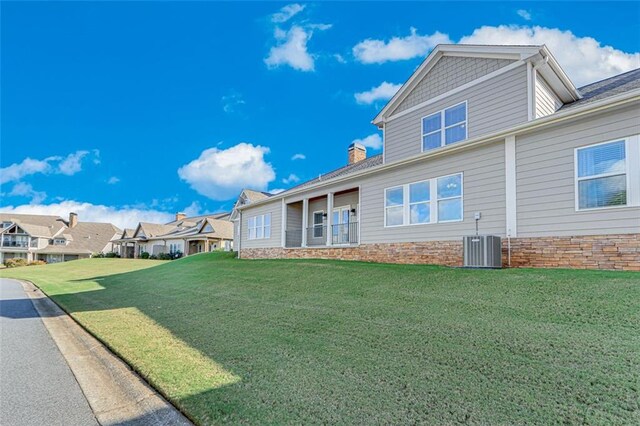 exterior space with a lawn and central AC