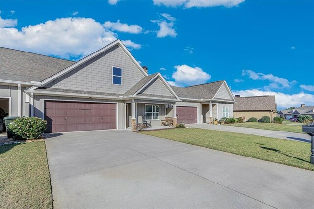 view of front of house featuring a garage and a front lawn