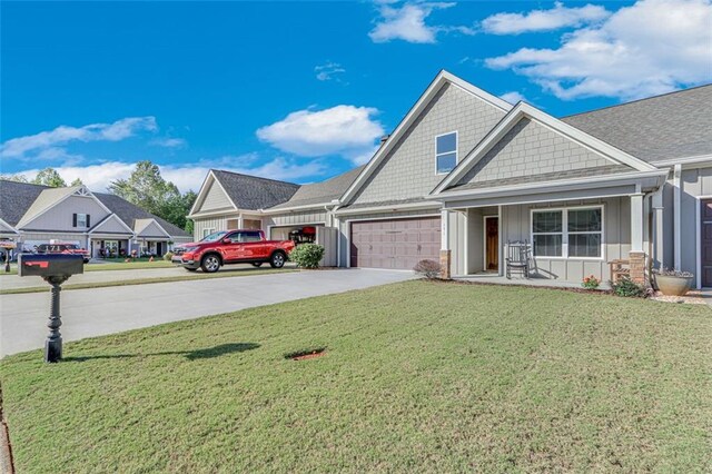 craftsman-style house featuring a garage and a front lawn