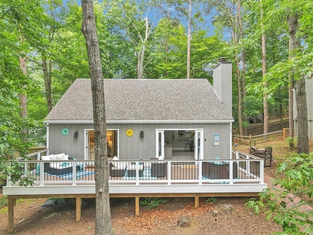 back of house featuring a deck