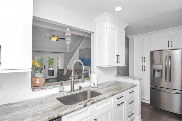 kitchen with stainless steel refrigerator with ice dispenser, sink, white cabinetry, and ceiling fan