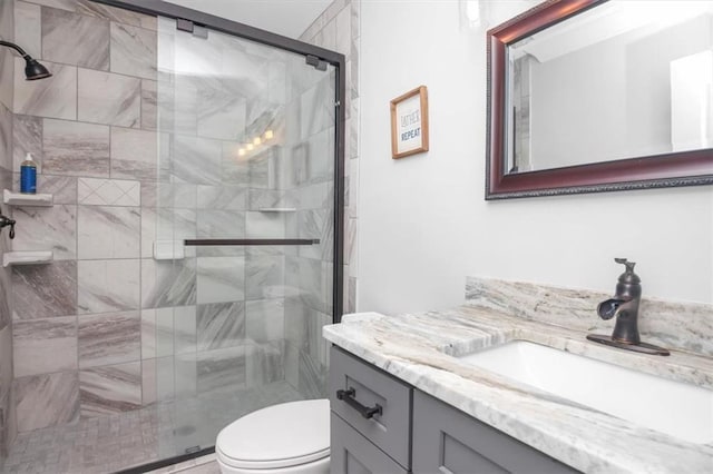 bathroom featuring walk in shower, vanity, and toilet