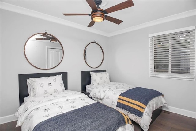 bedroom featuring ceiling fan, dark hardwood / wood-style flooring, and crown molding