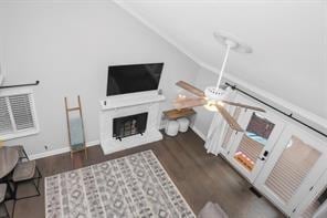 living room with ceiling fan, vaulted ceiling, and dark hardwood / wood-style flooring