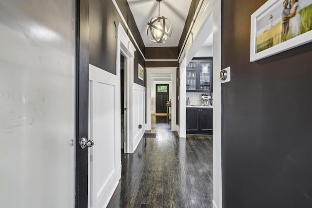 corridor with dark wood-style floors and baseboards