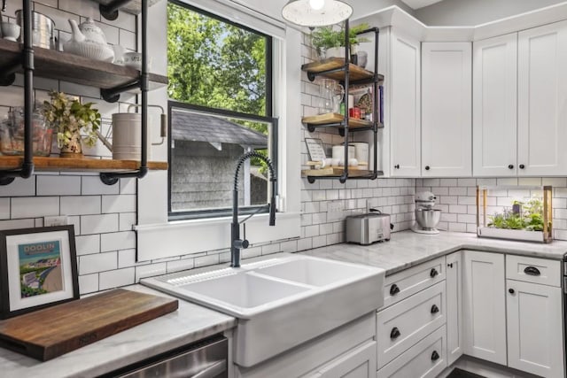 kitchen featuring open shelves, a sink, and decorative backsplash