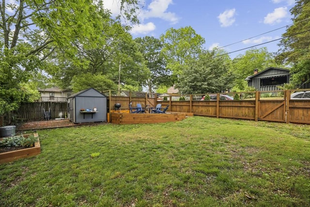 view of yard with a vegetable garden, a shed, and an outdoor structure