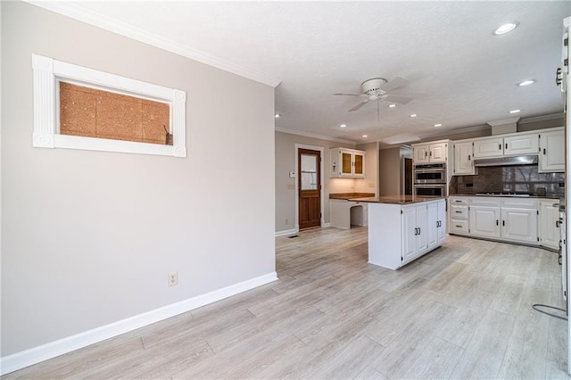 kitchen with gas cooktop, tasteful backsplash, light hardwood / wood-style floors, white cabinets, and a kitchen island