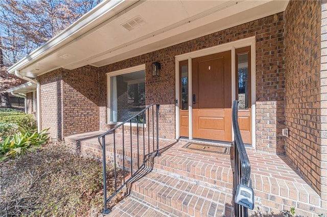 view of exterior entry with a porch