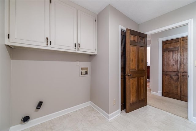 laundry area with hookup for a washing machine and cabinets