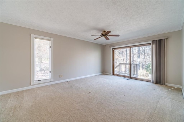 carpeted empty room featuring crown molding, ceiling fan, and a textured ceiling