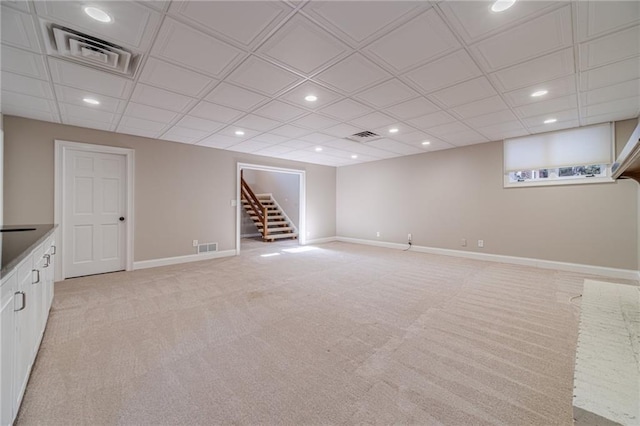 basement featuring light carpet