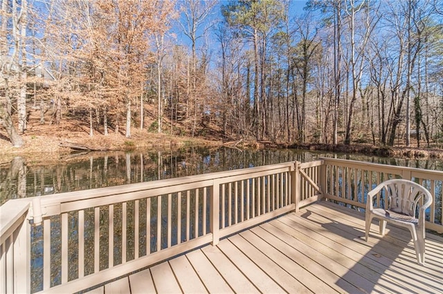 wooden terrace featuring a water view