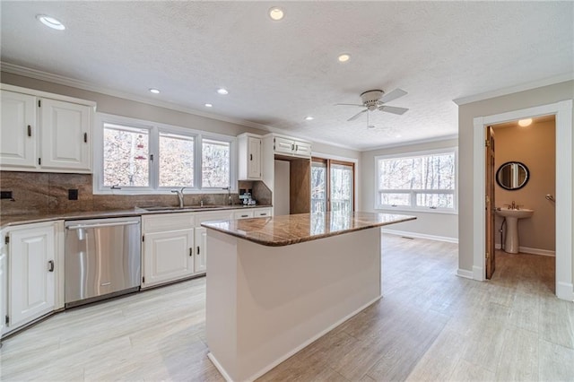 kitchen featuring a center island, stainless steel dishwasher, and white cabinets