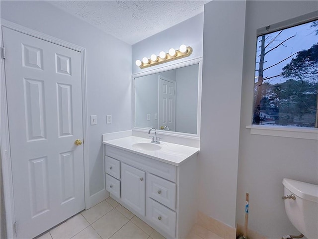 bathroom with vanity, tile patterned floors, toilet, and a textured ceiling