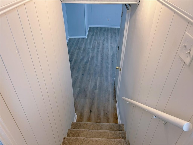 stairs featuring hardwood / wood-style flooring