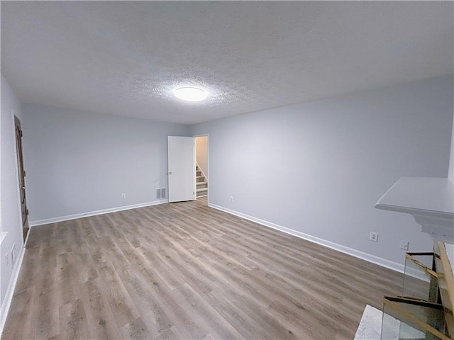 interior space with light hardwood / wood-style floors and a textured ceiling