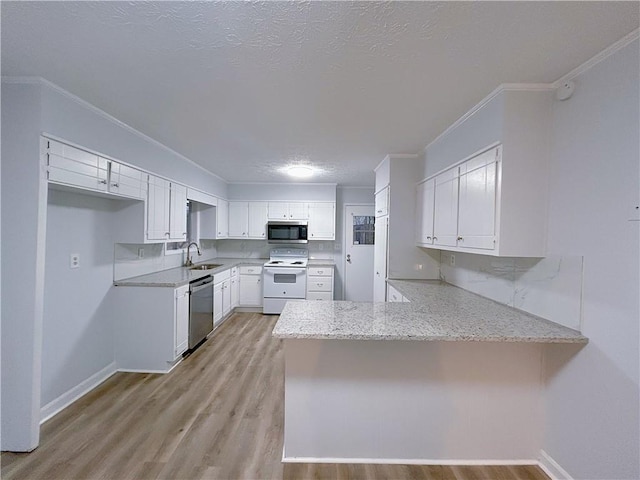 kitchen featuring white cabinets, ornamental molding, light hardwood / wood-style floors, kitchen peninsula, and stainless steel appliances