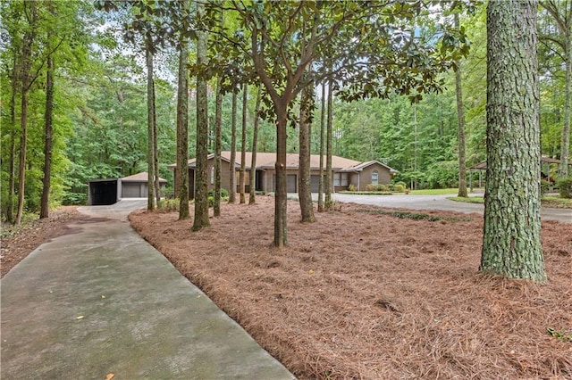 view of front of house with a forest view