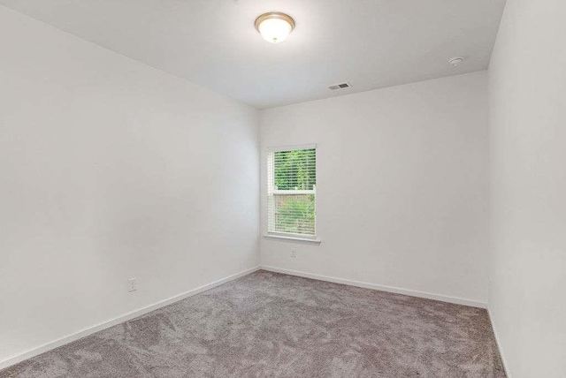 939 Brittfield Way, Loganville, GA 30052 - spare room featuring carpet flooring and a smoke detector