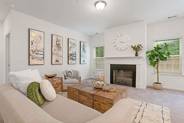 939 Brittfield Way, Loganville, GA 30052 - living area featuring healthy amount of natural light, a glass covered fireplace, and carpet