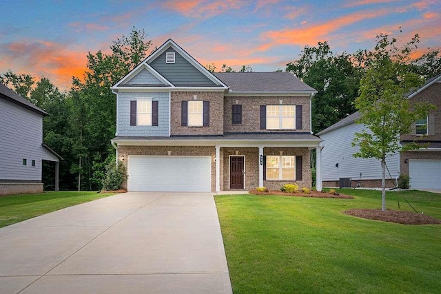 939 Brittfield Way, Loganville, GA 30052 - view of front of house featuring an attached garage, a yard, driveway, and brick siding