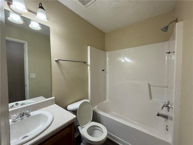 bathroom with vanity, visible vents, tub / shower combination, a textured ceiling, and toilet