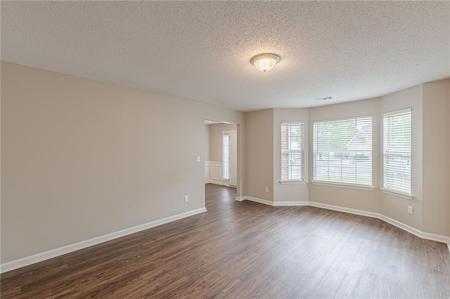 105 Kentwood Springs Dr, Hampton, GA 30228 - spare room featuring a textured ceiling, visible vents, baseboards, and dark wood-style floors