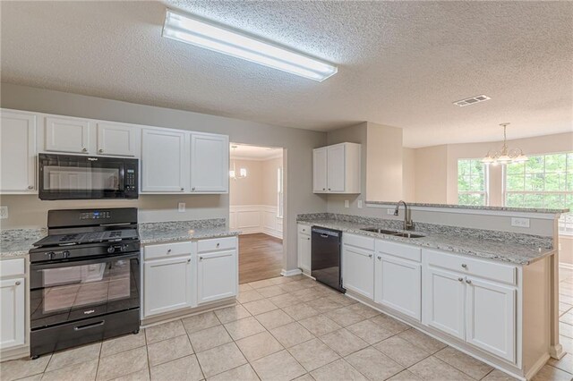 105 Kentwood Springs Dr, Hampton, GA 30228 - kitchen featuring a sink, a peninsula, black appliances, a chandelier, and white cabinets